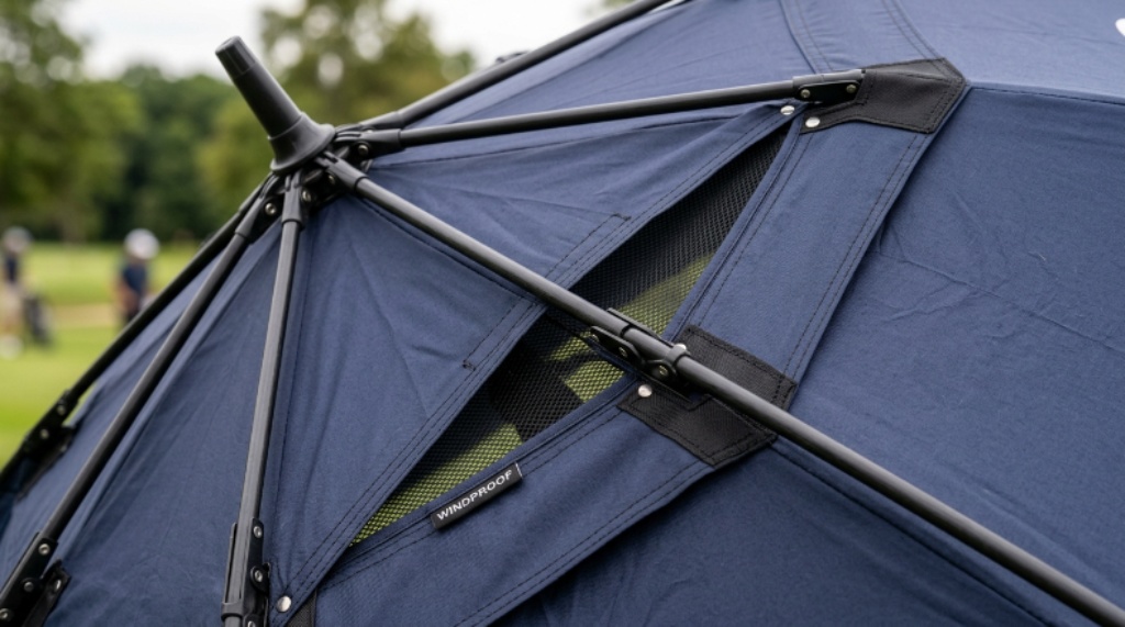 Close-up of a windproof golf umbrella showing the vented double canopy design and fiberglass frame ribs