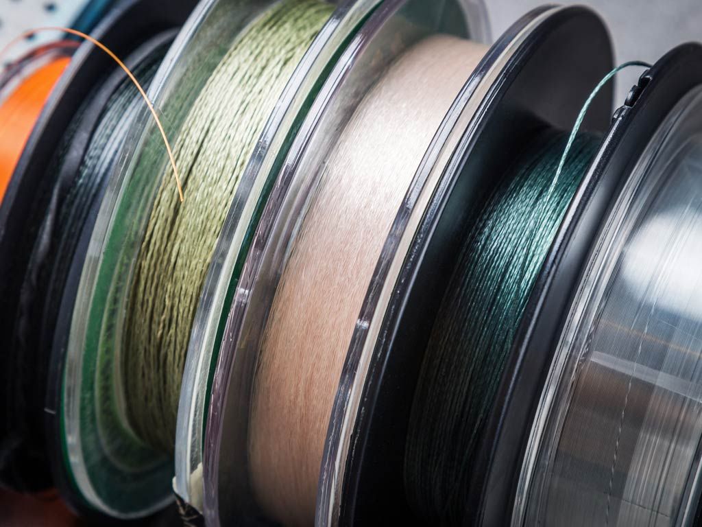 Angler casting with a durable budget-friendly fishing line on a lake